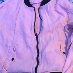 a pink zip up sweater